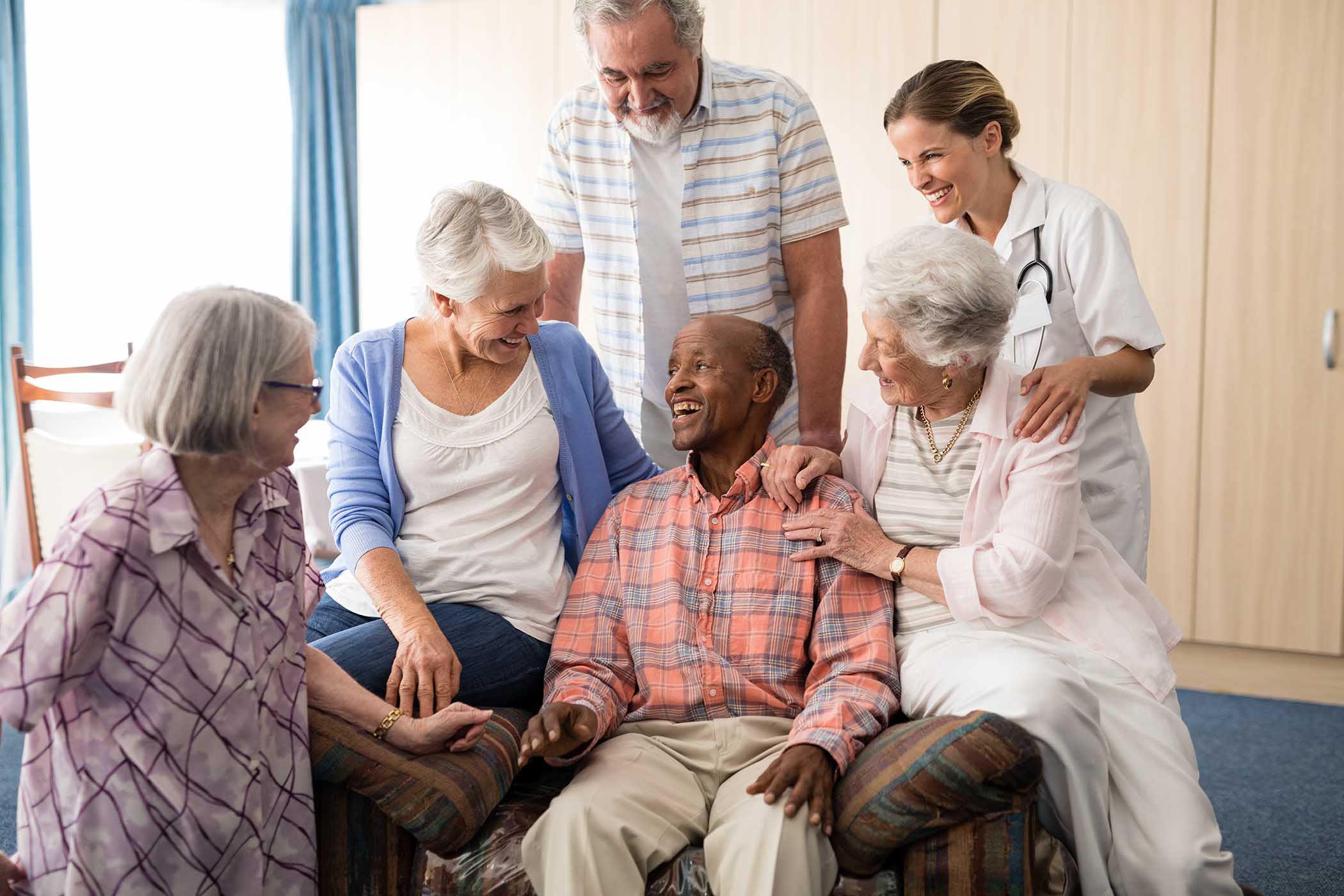 friends and female doctor looking at cheerful seni MWFUJSK.jpg