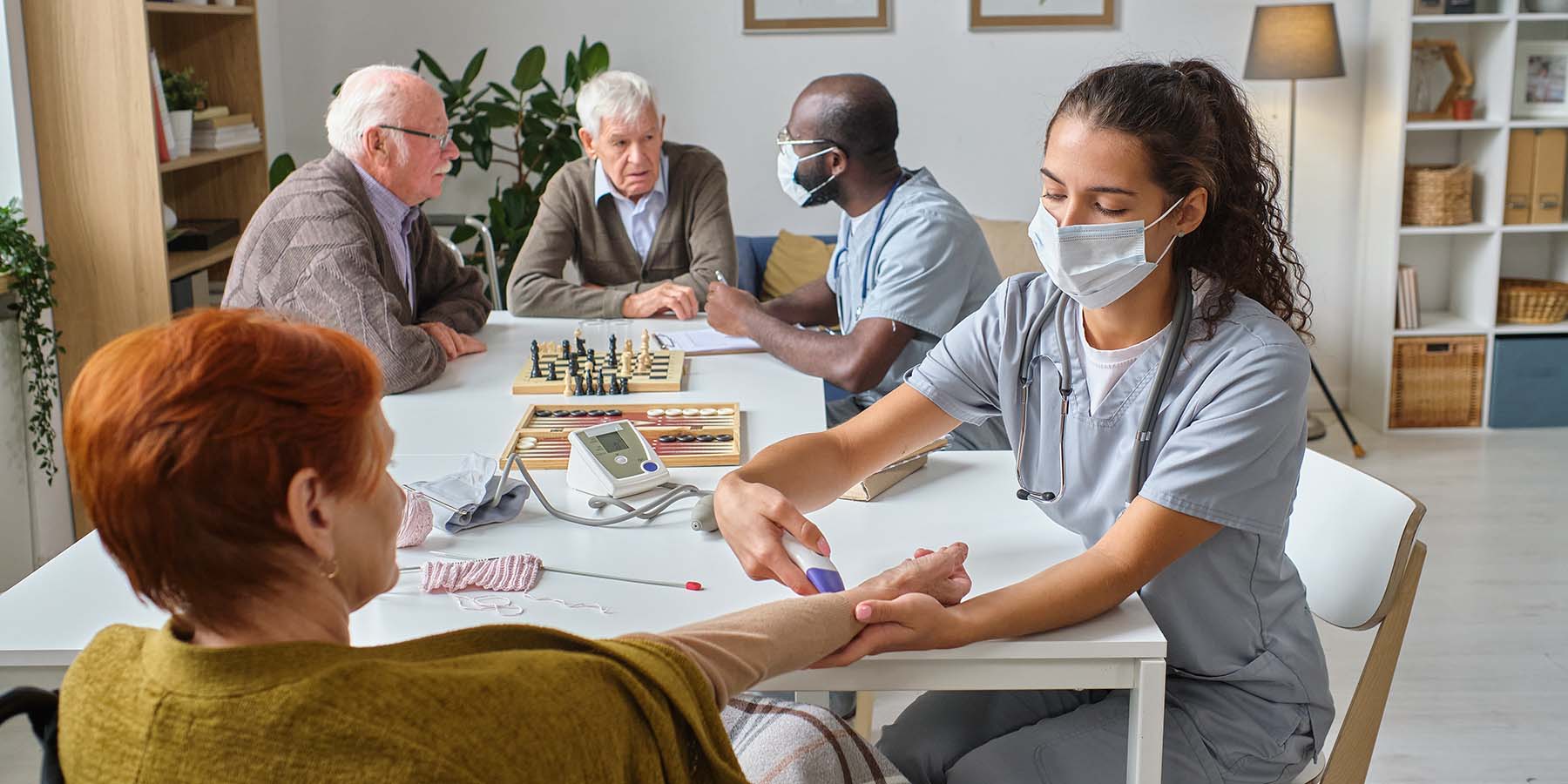 nurse holding medical exam for senior people FCWXYW.jpg