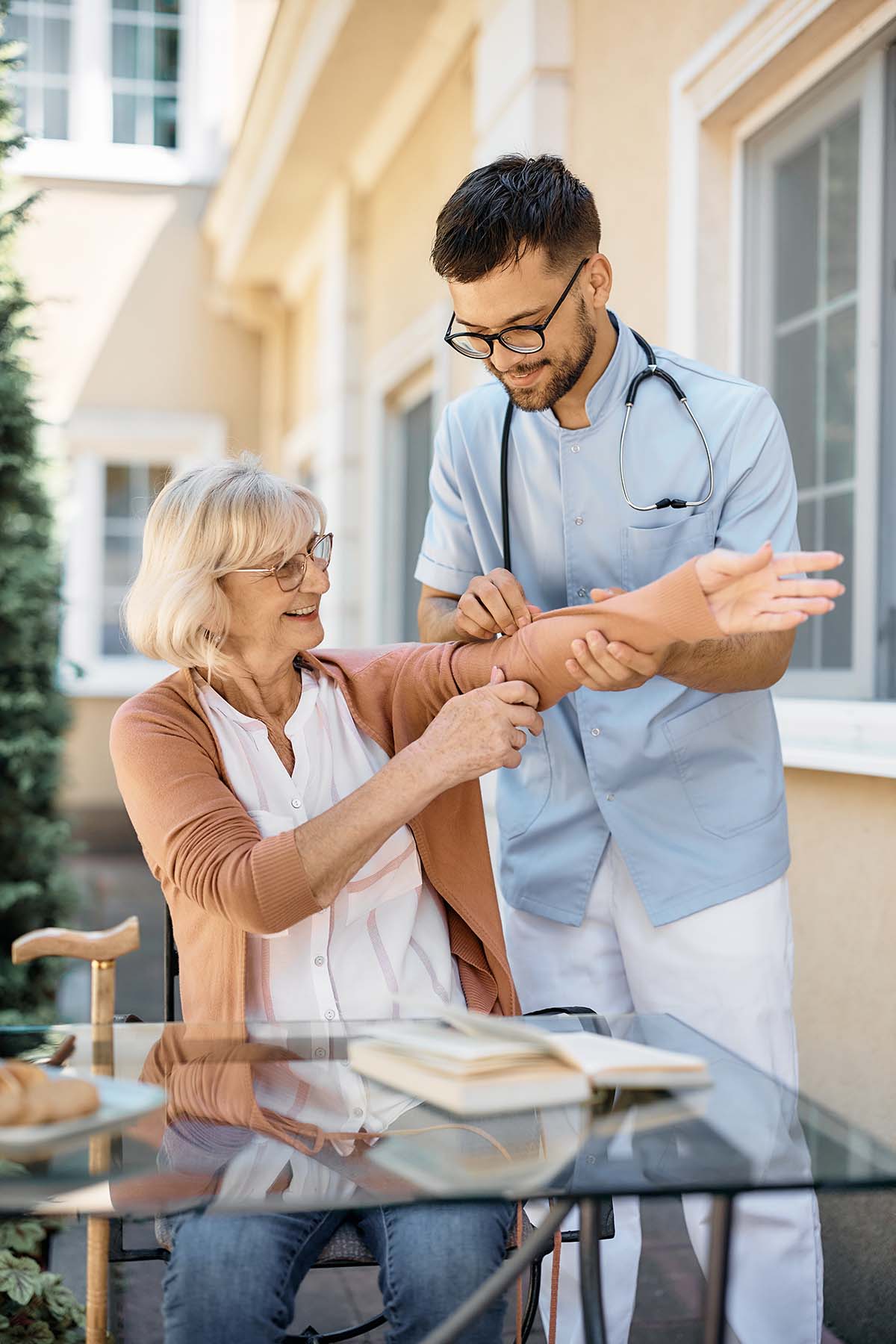 young caregiver assisting senior woman on the nurs KVJSC.jpg